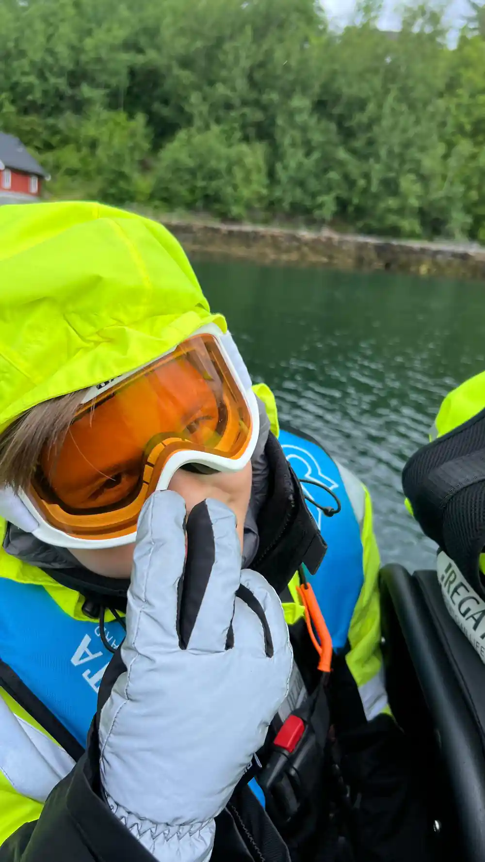 A child in a yellow suit and orange goggles aboard