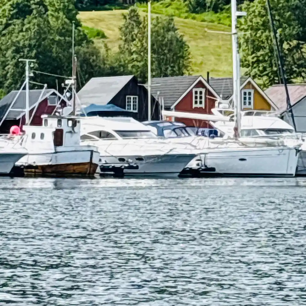 Fishing boats and red boathouses at a small quay