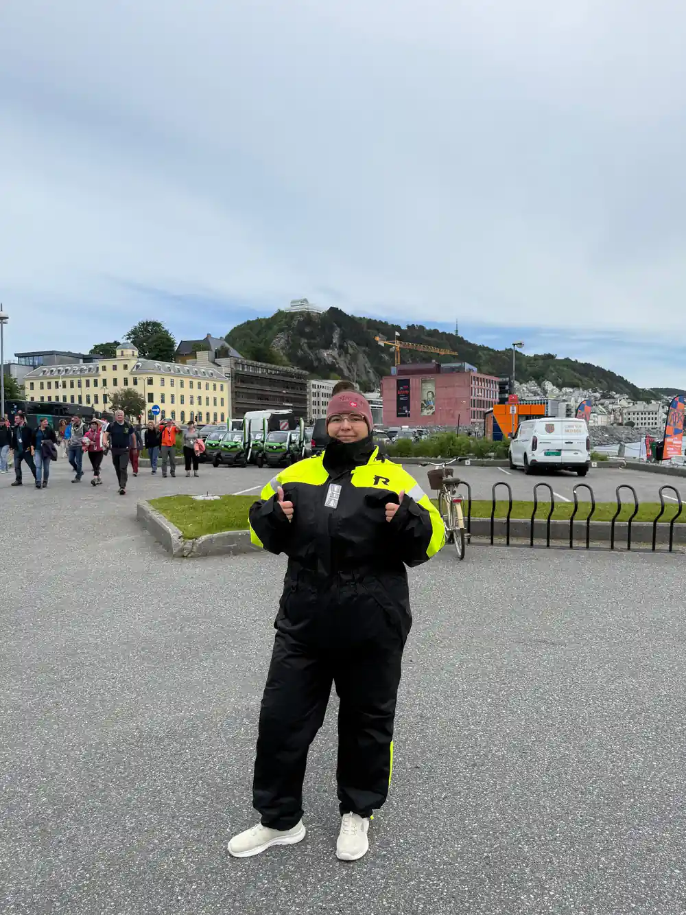 A passenger in a flotation suit on the Alesund waterfront