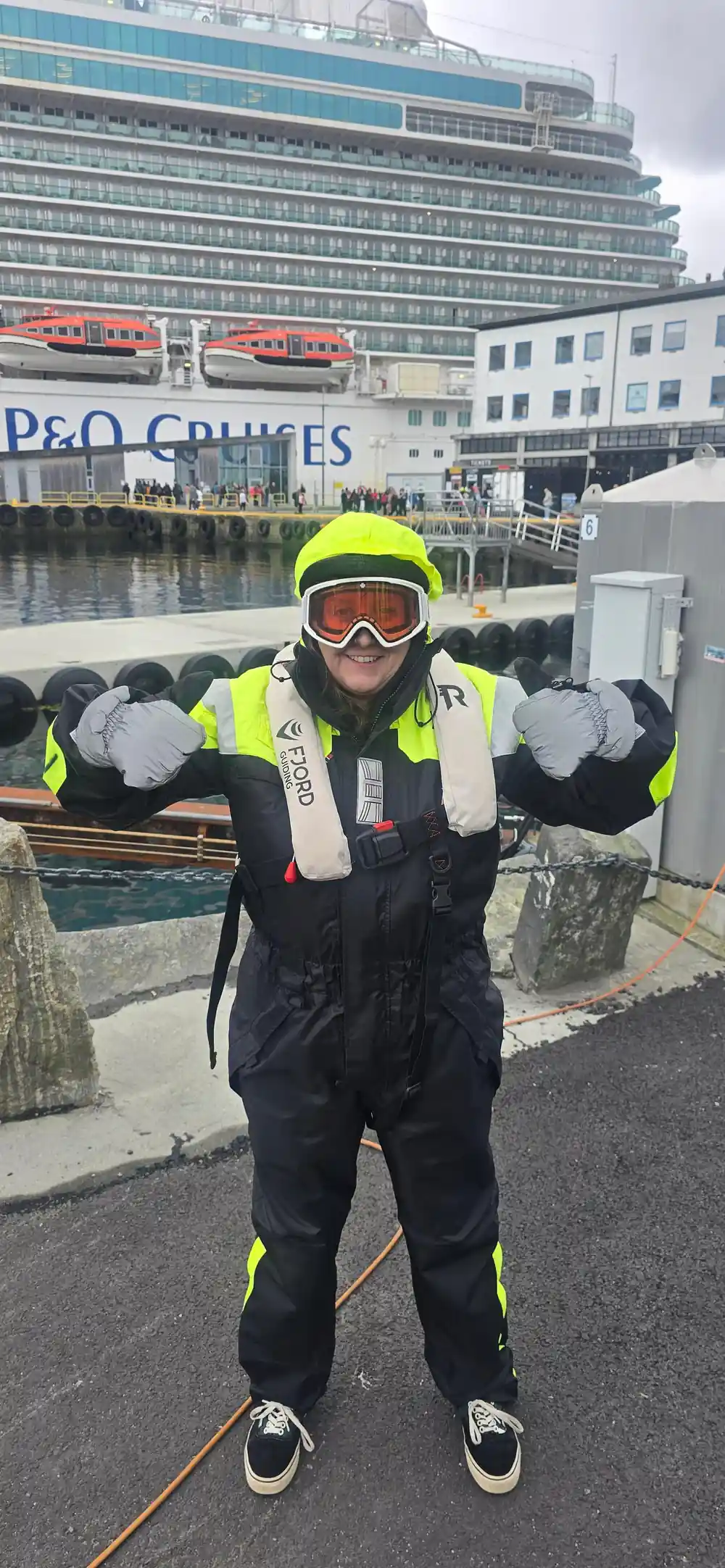A passenger in a flotation suit at the cruise terminal