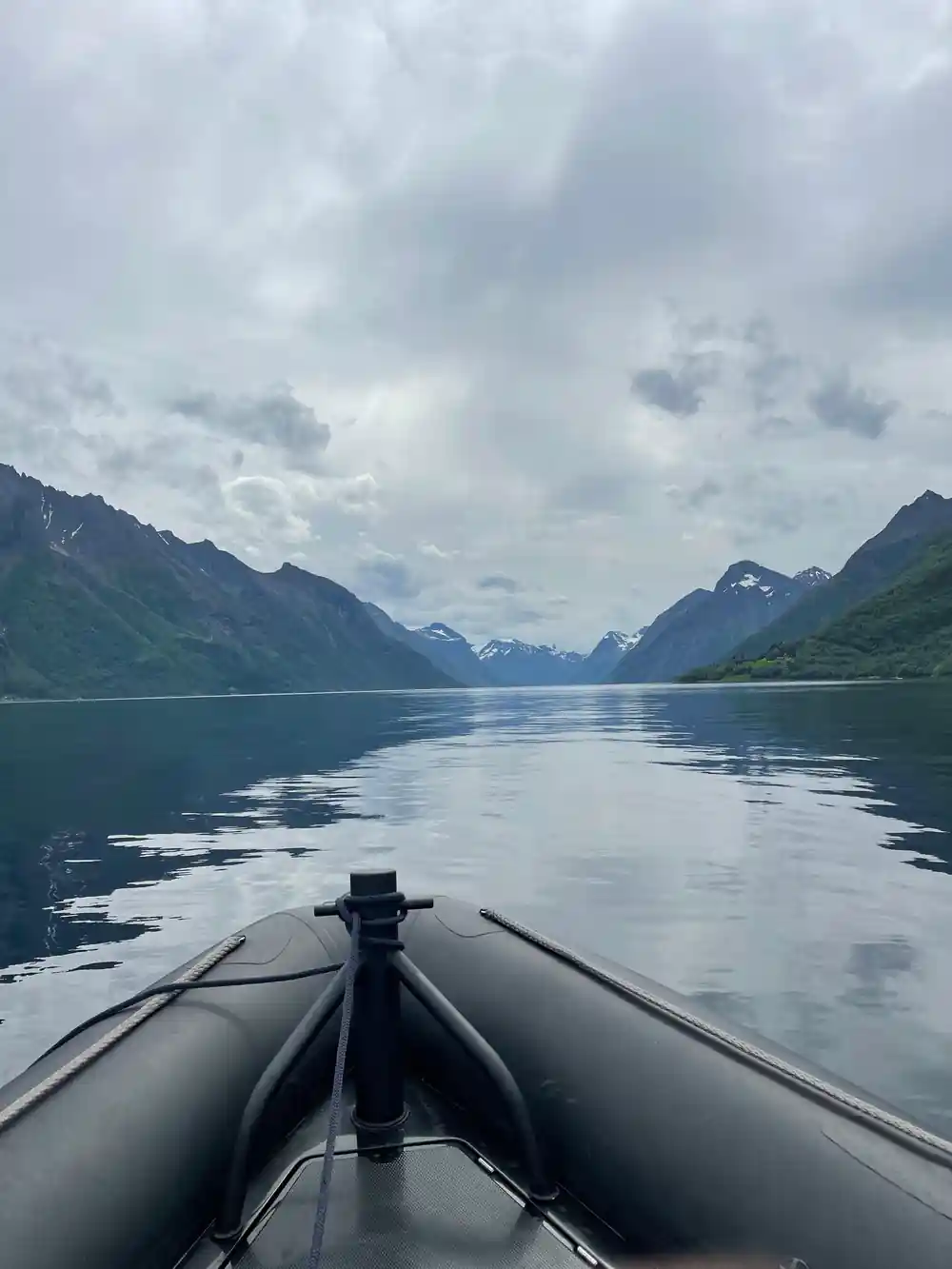 The RIB's wake running back down a long still fjord