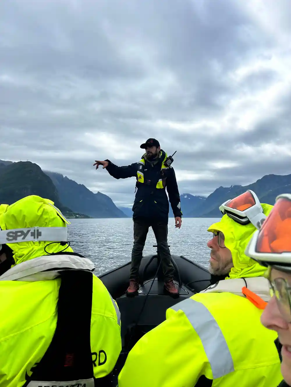 The skipper standing on the bow talking to passengers