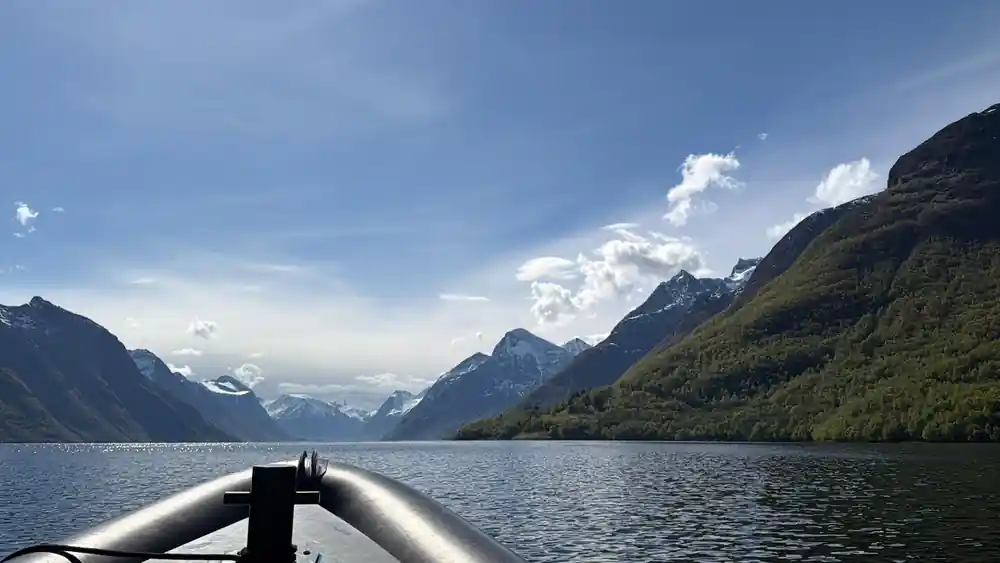 Snow-capped mountains at the head of a blue fjord