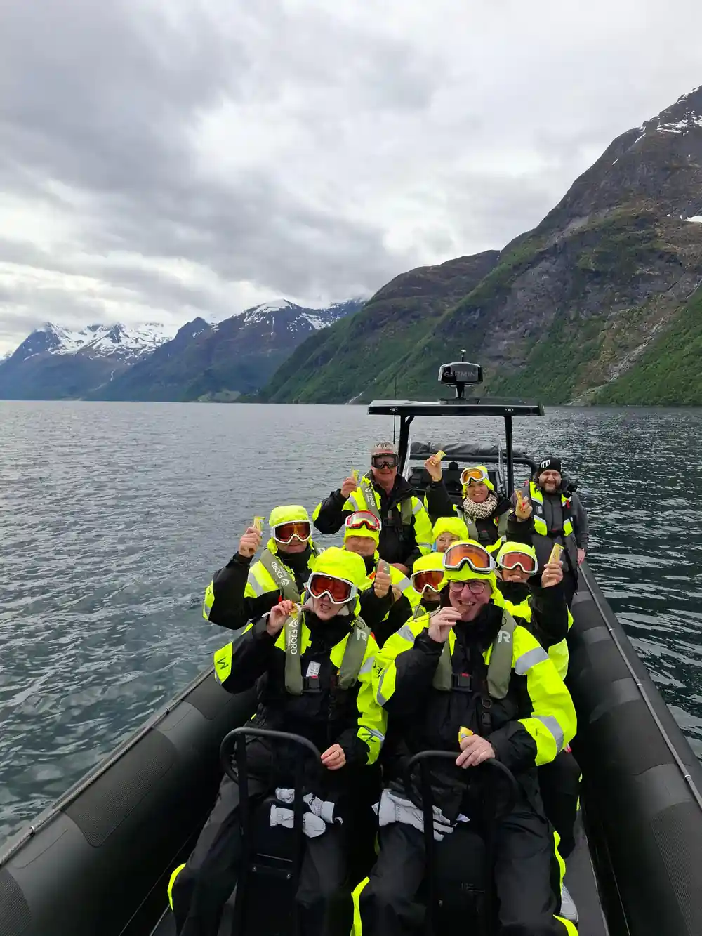 The whole group in suits and goggles aboard the RIB